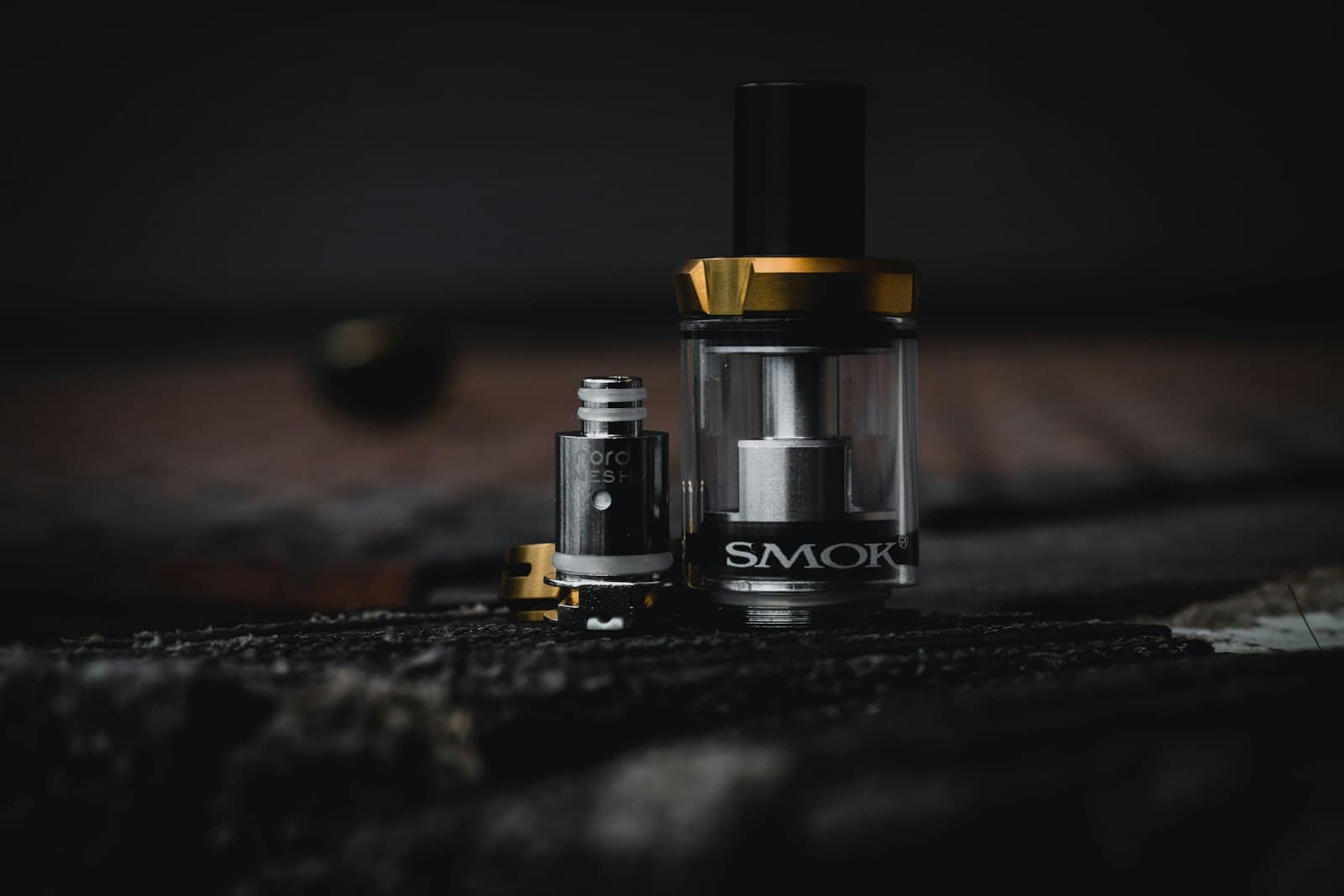 Close-up of a clear atomizer tank showing the coil and wicking chamber inside